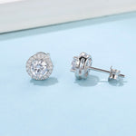 Four-claw moissanite round stud earrings by Yeha Maison featuring sparkling jewelry with elegant round-cut stones.