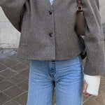 Women's collarless button-front short coat by Yeha Maison, featuring a sleek design and tailored fit in a stylish outerwear style.