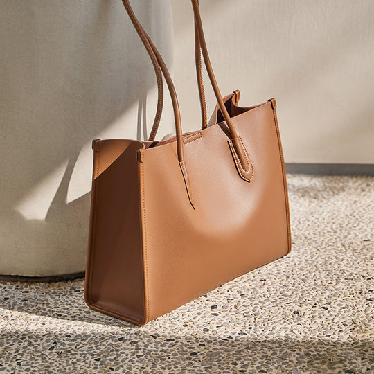 Women's ivory leather tote bag with tan trim from Yeha Maison, featuring a spacious design and stylish accents.