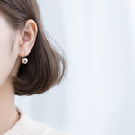 Women's Japanese style glossy round S925 silver ear hooks, elegant jewelry earrings with shiny finish and comfortable fit.
