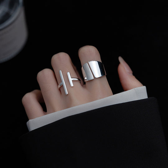 Silver wide-face smooth adjustable ring from Yeha Maison, featuring a sleek, polished design on a jewelry display.