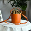 Women's handcrafted leather bucket bag by Yeha Maison, featuring a stylish design with a drawstring closure and shoulder strap.