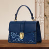 Women's red cowhide crossbody bag with cloud embroidery and top-handle by Yeha Maison, featuring a stylish bag design.