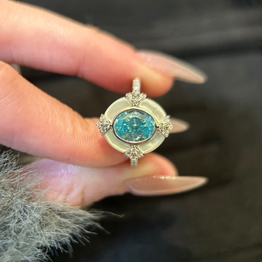 Women's aquamarine shell S925 sterling silver ring featuring a polished gemstone and intricate band design.
