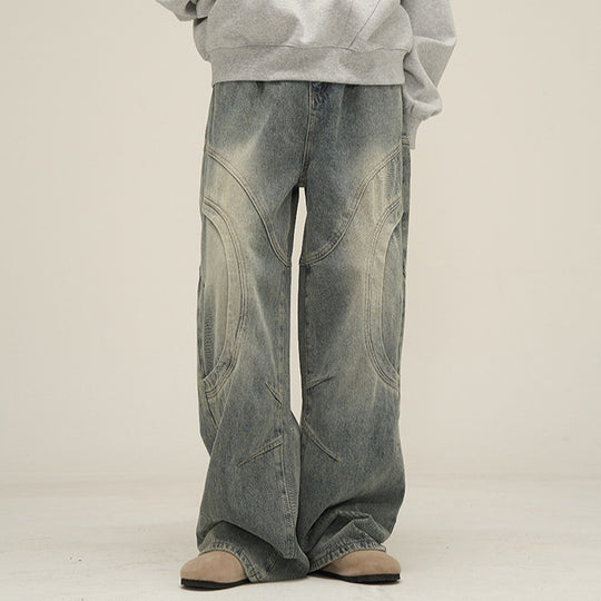 Men's deconstructed wide-leg jeans by Yeha Maison, featuring arc-seam detailing and a relaxed fit, shown in a natural denim wash.