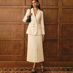 Women's double-breasted blazer and pleated midi skirt suit by Yeha Maison, shown on a model, stylish and professional attire.