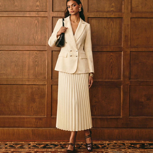 Women's double-breasted blazer and pleated midi skirt suit by Yeha Maison, shown on a model, stylish and professional attire.