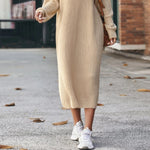 Yeha Maison chunky ribbed turtleneck midi sweater dress hanging on a rack, showcasing its cozy knit texture and classic silhouette.