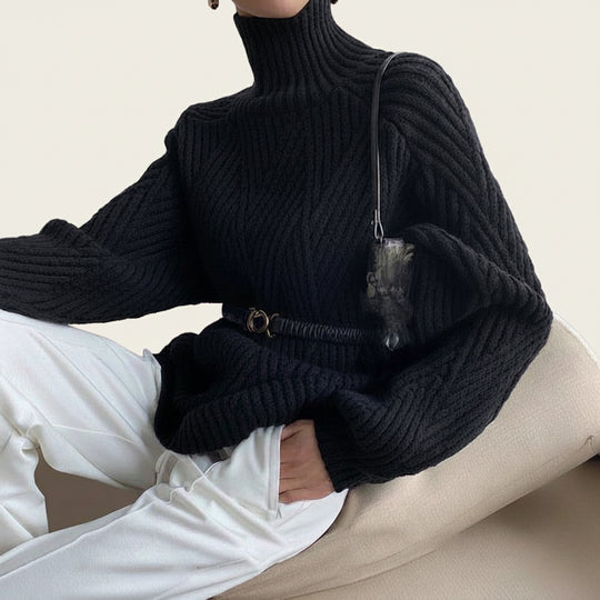 Women’s oversized turtleneck cable-knit sweater by Yeha Maison, featuring chunky knit pattern and relaxed fit in neutral tones.