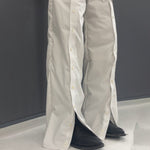 Men's deconstructed wide-leg trousers by Yeha Maison, featuring detailed stitching and relaxed fit, shown on a model.