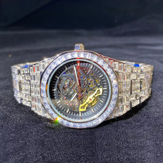 Men's Yeha Maison iced out baguette diamond skeleton mechanical watch with detailed dial and sparkling diamond accents.
