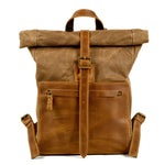 Men's wax canvas and leather roll-top backpack with adjustable straps and multiple compartments, designed by Yeha Maison.