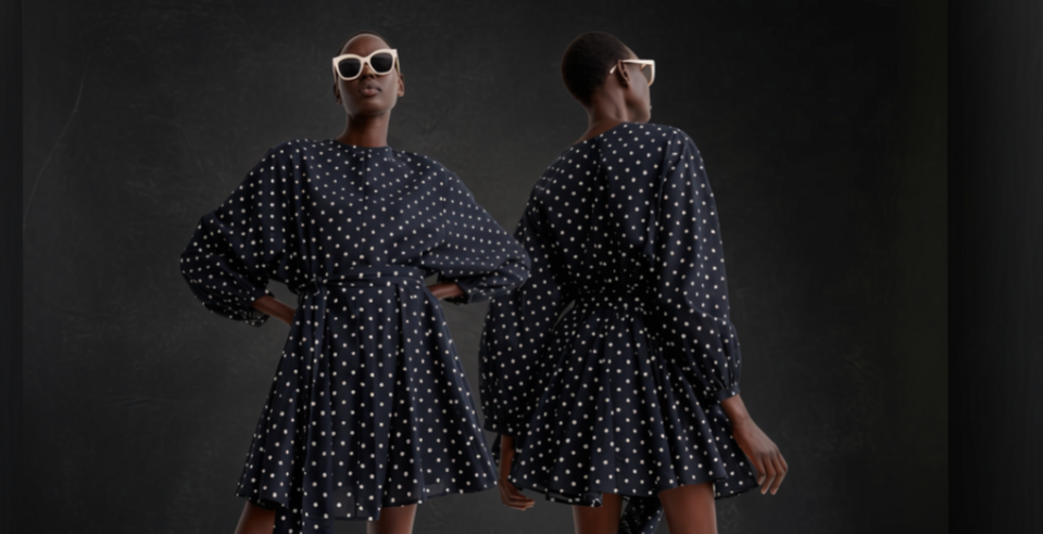 A model wearing a navy blue and white polka dot dress, shown from both the front and back against a dark textured background.